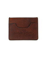 El Tarjetero De Res by VAQUERO VAQUERA es un tarjetero de piel marrón con grano visible, bordes cosidos, logotipo de la marca en relieve y una única ranura para tarjetas, que se muestra sobre un fondo blanco.